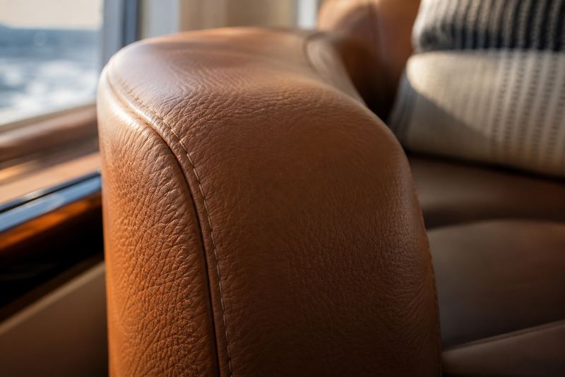 Cognac leather-look grain on a salon armrest