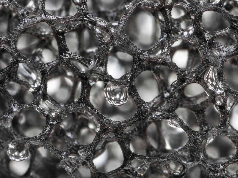 Close-up of open-cell quick-dry foam with water passing through the cells
