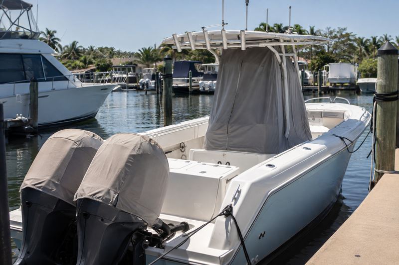 Center console with a faded, torn console cover and sun-bleached outboard covers