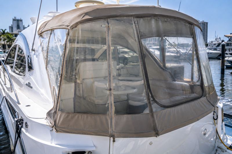 Cabin cruiser cockpit with a cloudy, yellowed, scratched clear vinyl enclosure