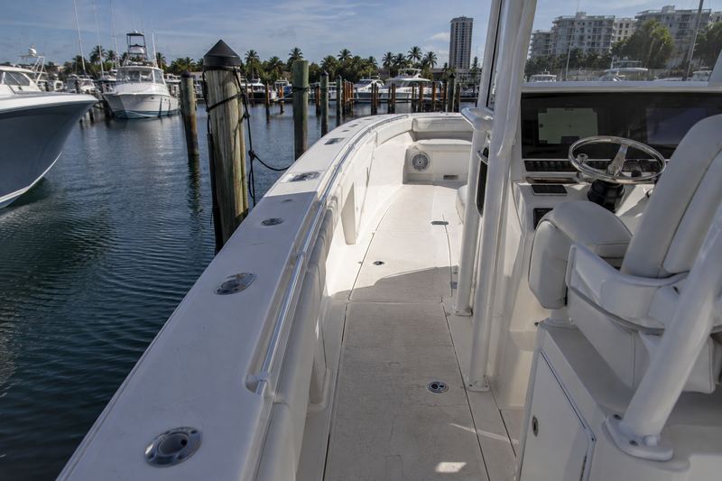 Deck of a 33 ft center console with worn non-skid and cracked vinyl patches