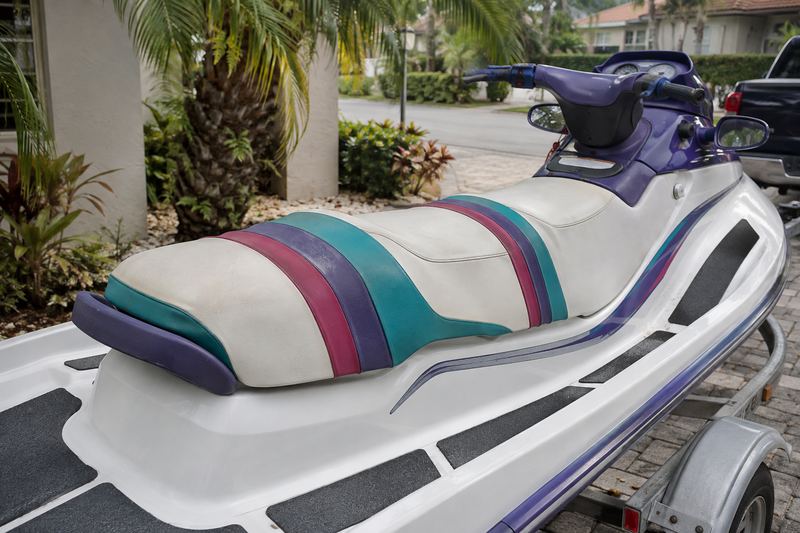 Three-seater jet ski, worn seat cover