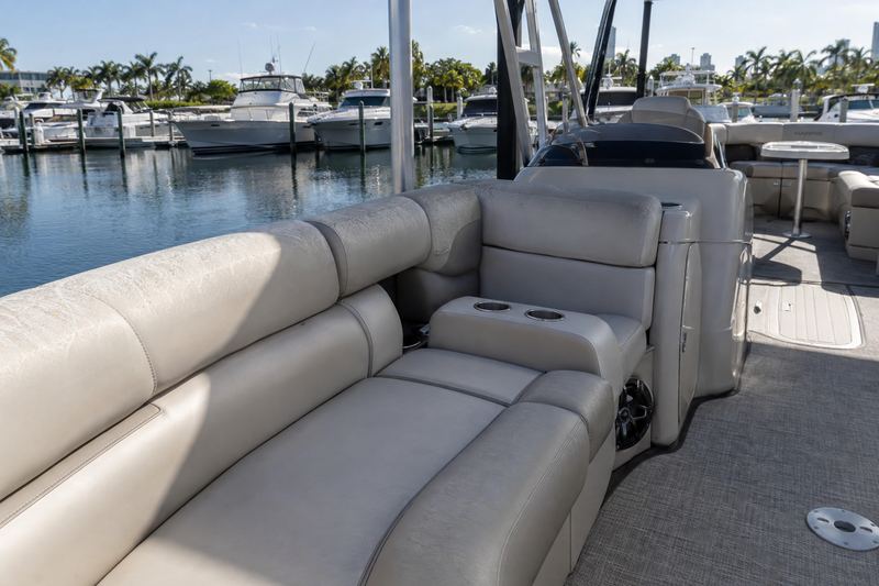 Pontoon lounge seats in cracked, faded grey and burgundy vinyl