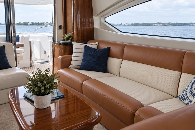 Motor yacht salon, sofa in cognac leather with cream seat panels