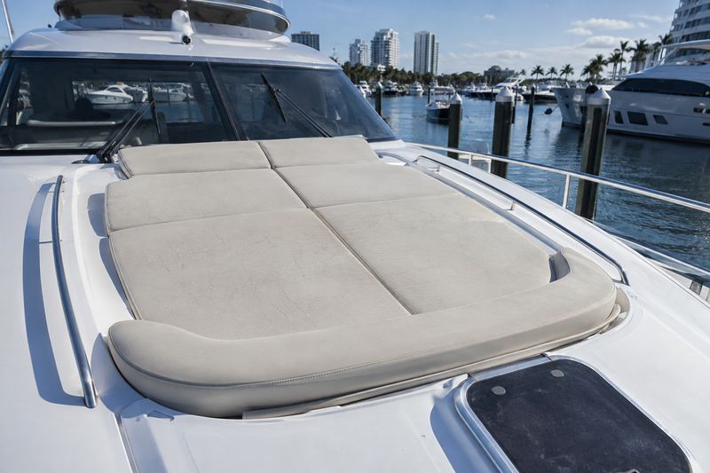 Motor yacht foredeck, worn grey sunpad