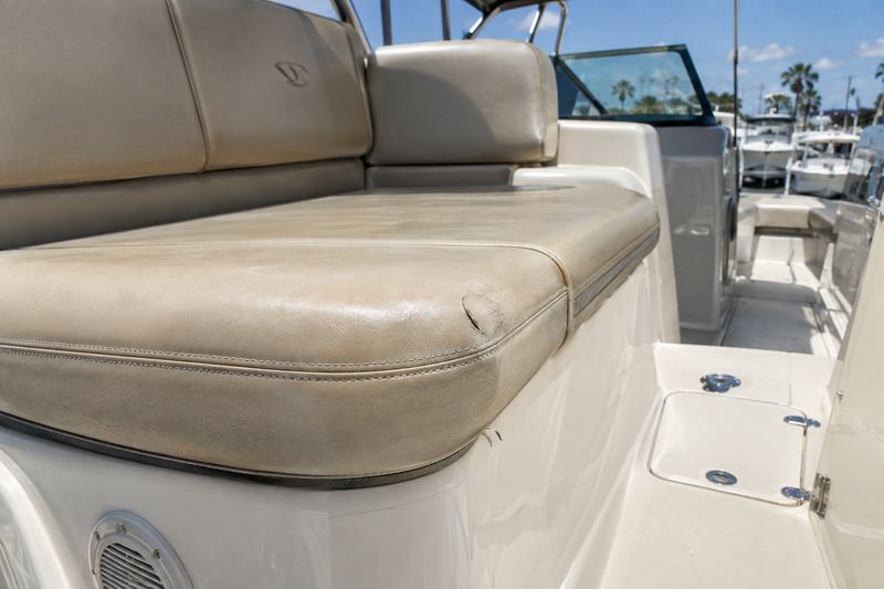Beige cushion corner with a torn, faded seam